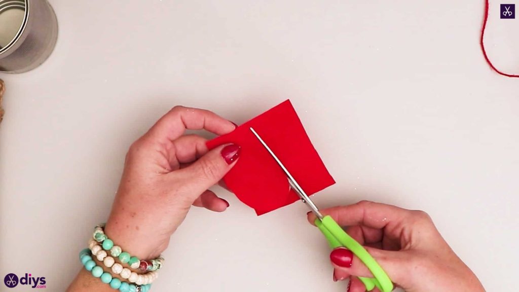 Boîte de conserve enveloppée de ficelle contenant du papier rouge
