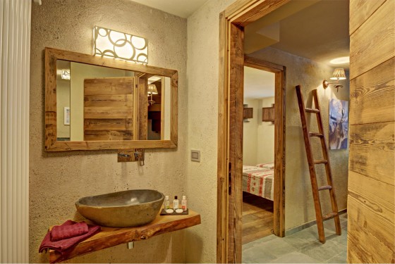 Conception de salle de bain rustique avec un lavabo en pierre