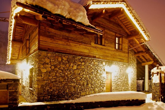 Conception de maison en pierre et en bois, photo prise la nuit